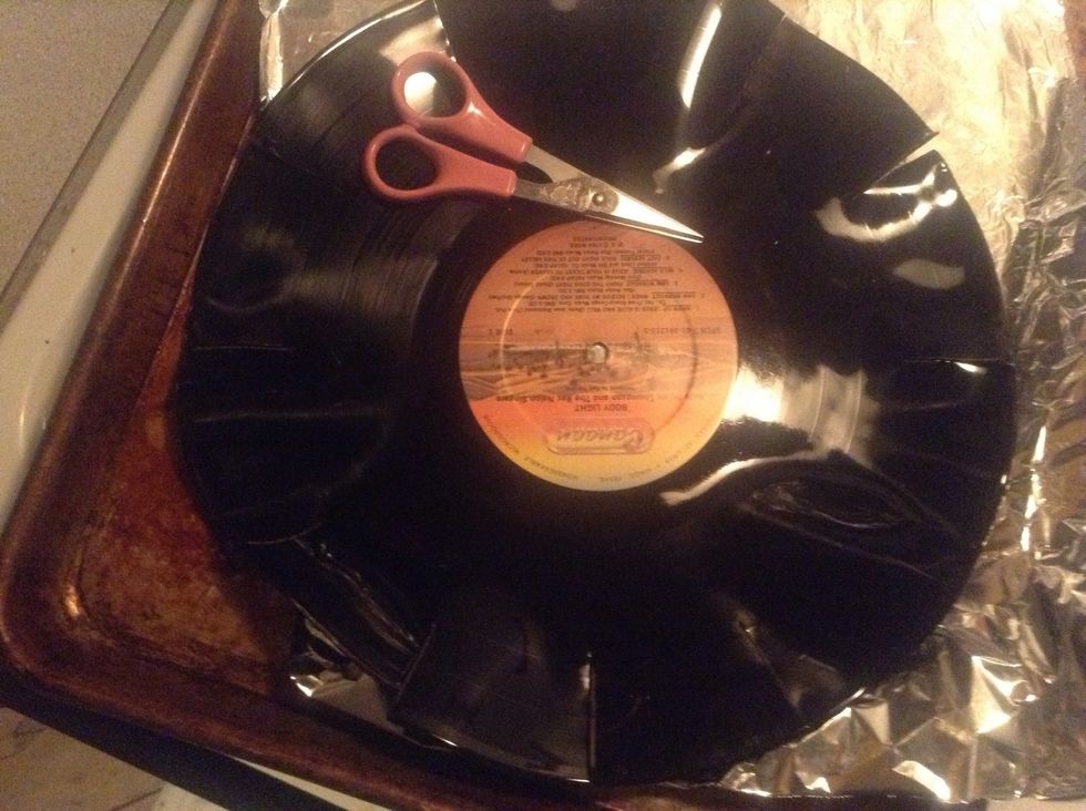 Begin to cut the places where you marked for the numbers to be with scissors. It may take a few re-heatings to cut all the marks. Do not try to work with it when its cooled! It will snap.