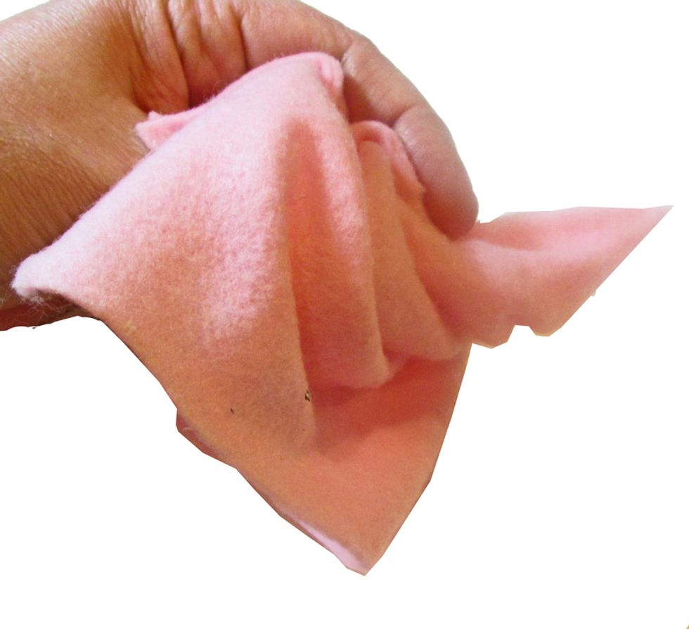 Begin to gather the cone, turning it "inside out." As you gather, you will form the rose shape. Have a piece of scrap felt handy to glue to the bottom of the flower.