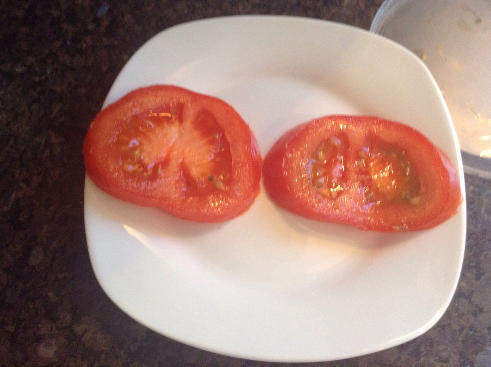 Begin to plate the tomatoes horizontally on a small plate like so