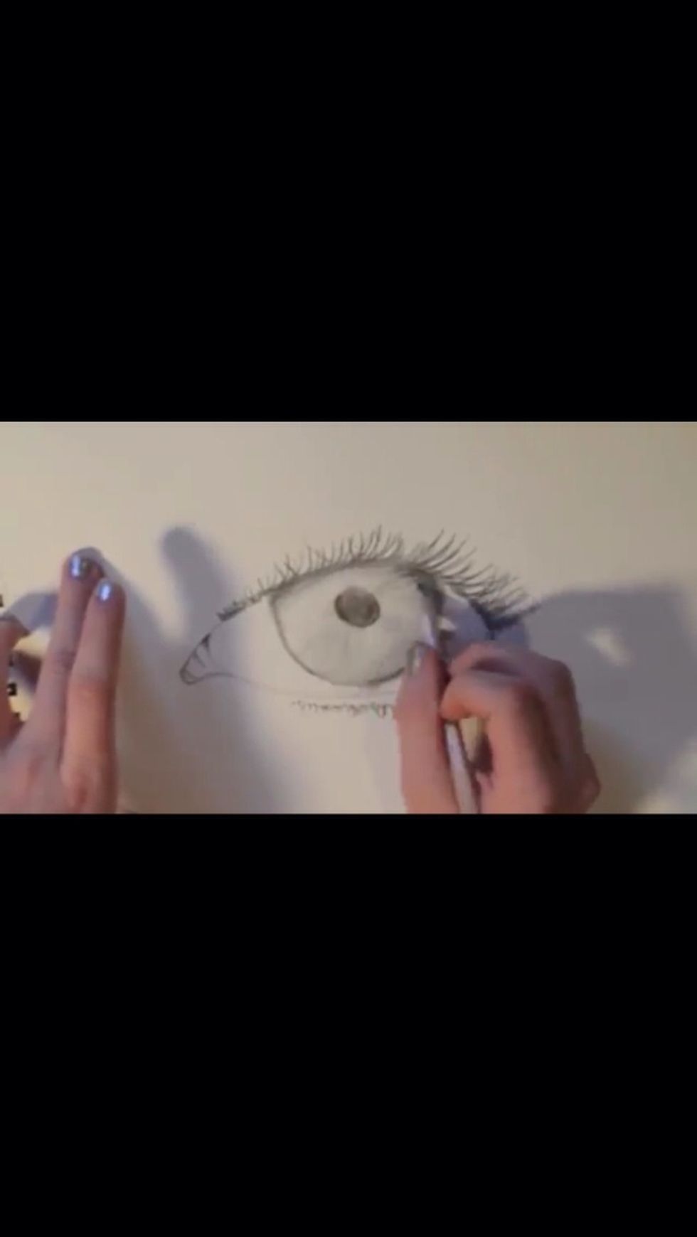 Begin to shade in the pupil and iris. Take your time on this step
