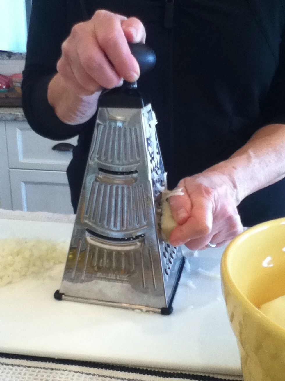 Begin to shred your potatoes.
