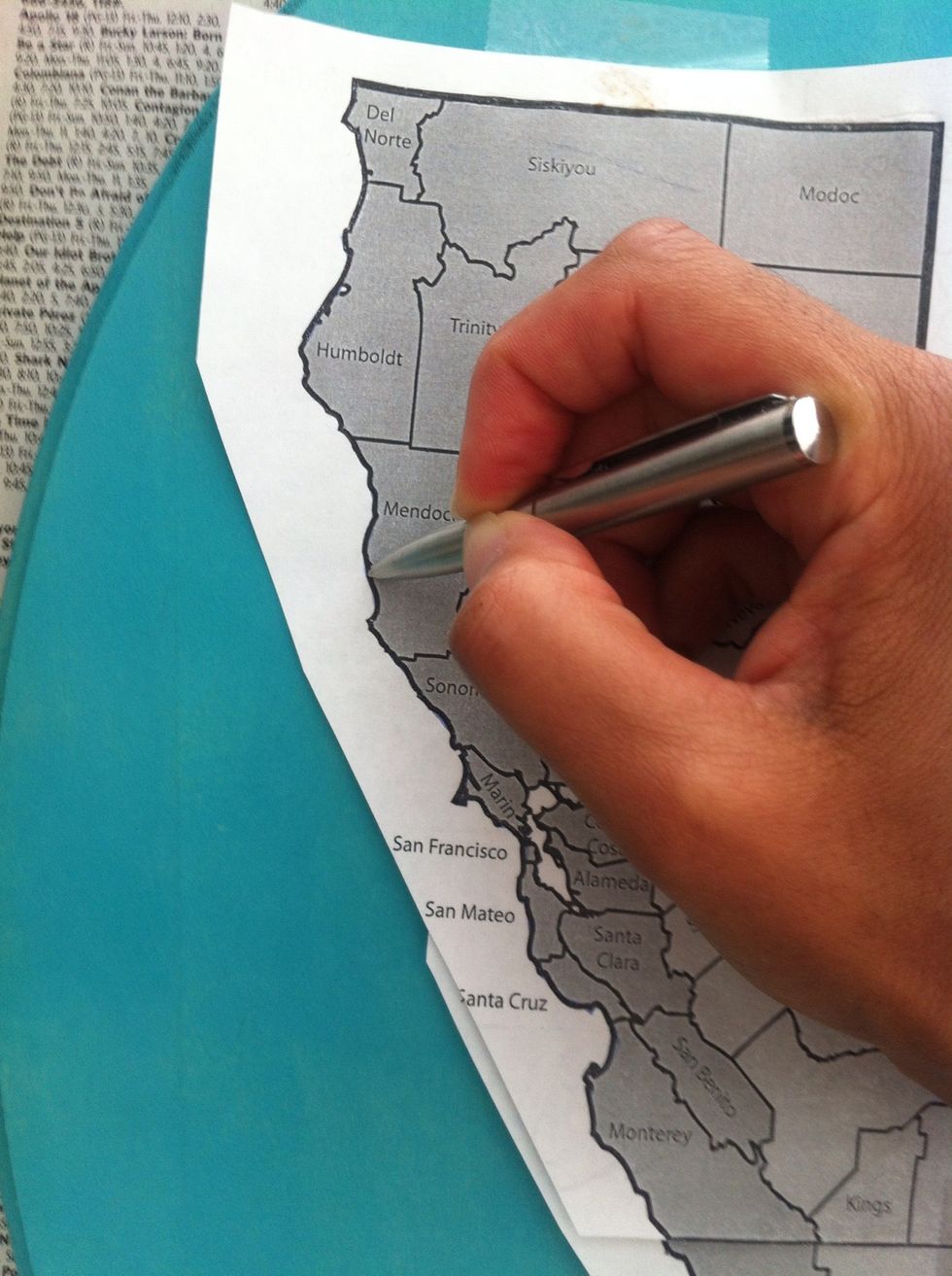Begin to trace the outline of the map with a ball point pen, pushing pretty hard while you do. Go around the entire state.