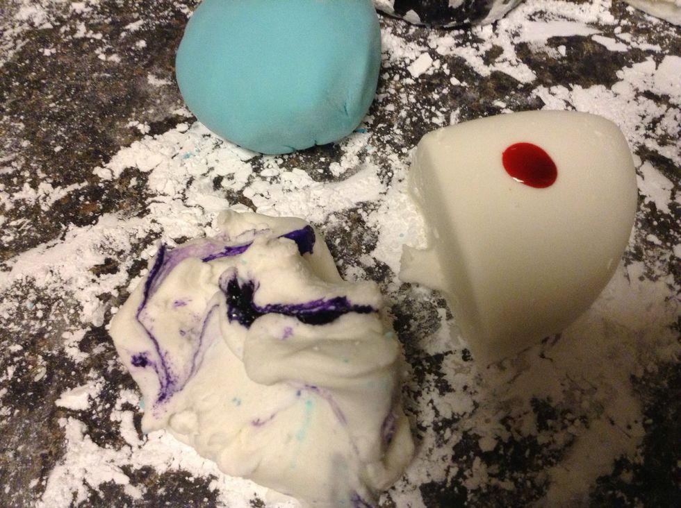 Begin to twist the color into the mixture. Simply twist the fondant and knead. Use plastic cooking gloves to prevent messy hands!