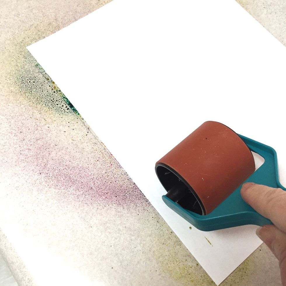 begin transferring design from plate to page by rolling over the plate with the brayer. be sure you roll over the entire surface. paints and inks will "smoosh" slightly in direction you roll.