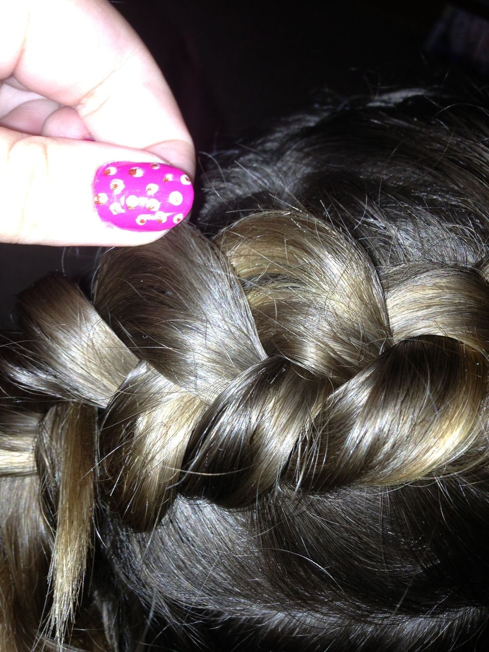 Begin tugging on the elbows of the braid to create a pancake braid.