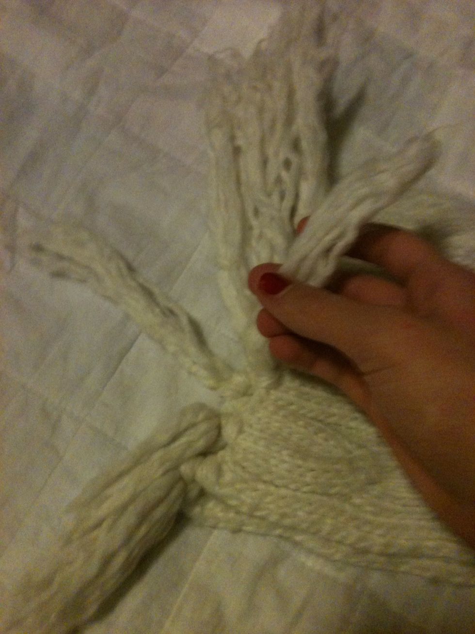 Begin tying the corresponding tassels together.