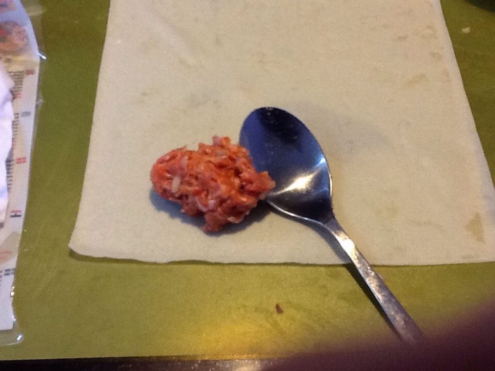 Begin with a wrapper on your board. Take a tablespoon full of mixture.