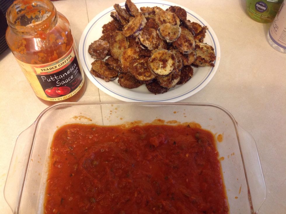 Begin with adding the tomato sauce at the bottom of a baking dish. I lightly spray the baking dish with cooking spray to prevent any staining of the sauce. I use a very good store-bought sauce here.
