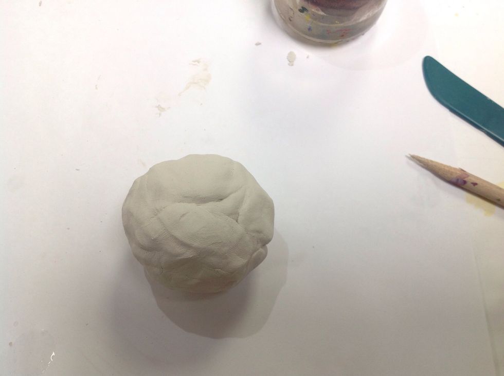 Begin with by rolling a ball of clay. Have your water and toothpick nearby. A plastic butter knife can also be handy, or clay tools.