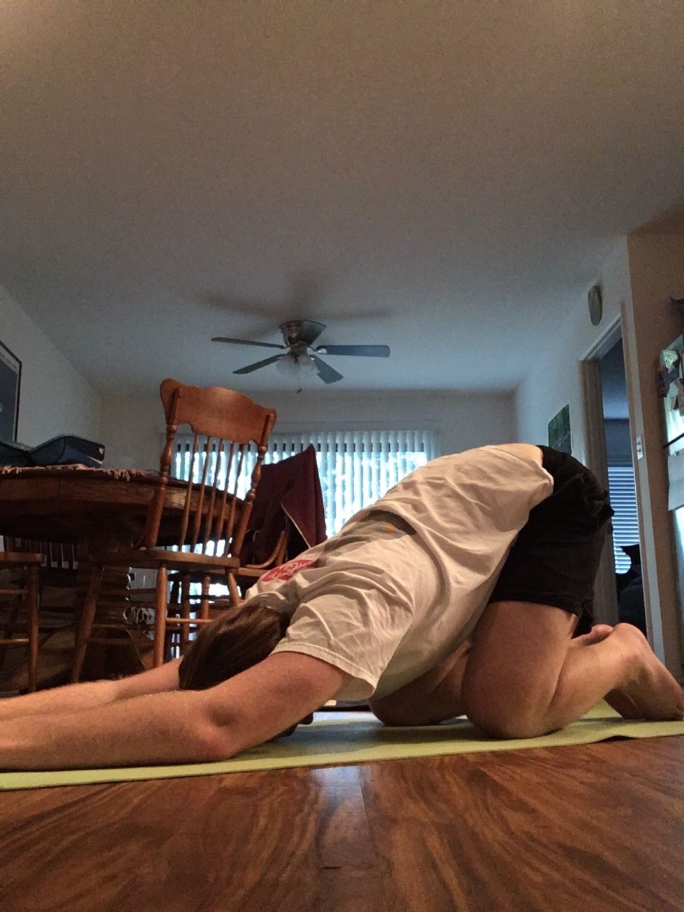 Begin with the Child's Pose or Balasana. From a kneeling position, bring your chest down onto your thighs and your forehead to the floor.