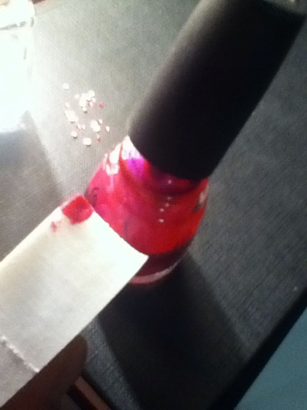 Begin with the pink nail polish you'll add it to the make-up applicator. Then you start painting the nail