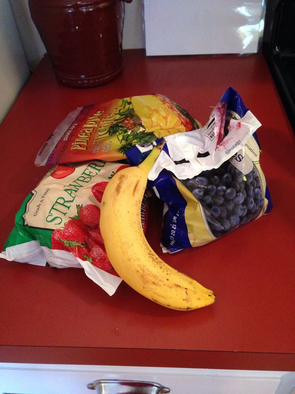Begin with your fruit. A banana is the foundation, but the frozen fruit can be anything from berries to mango to apples...Be creative! I like a combination of strawberries, pineapple, and blueberries.