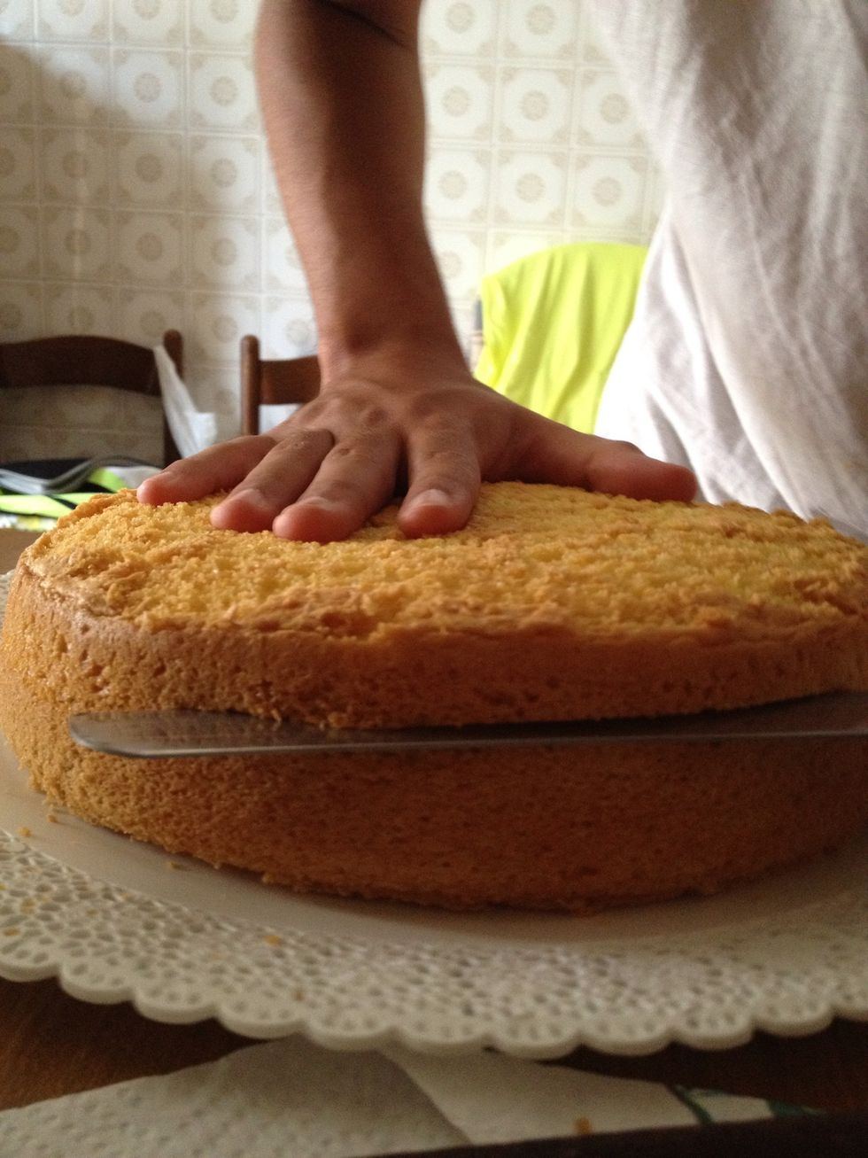 begins to cut the cake into three equal parts like this