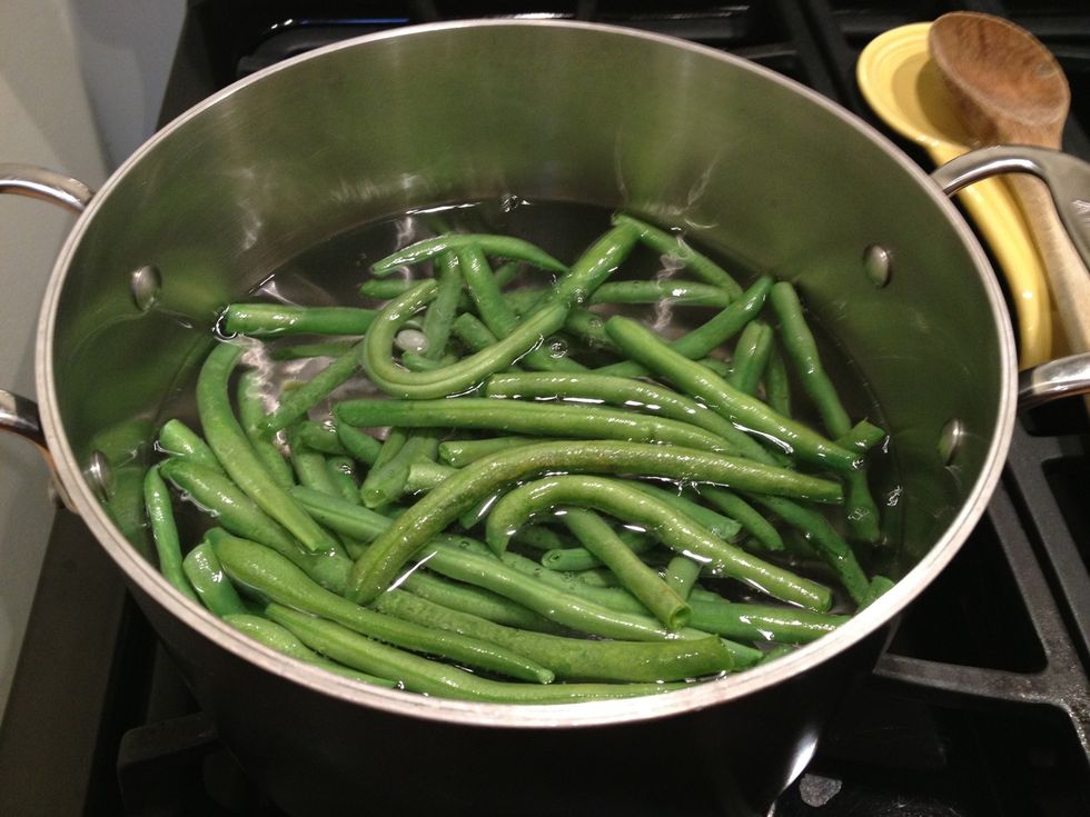 Being a pot of water to a boil.  Add salt and the green beans. Boil the green beans for 3-4 minutes.