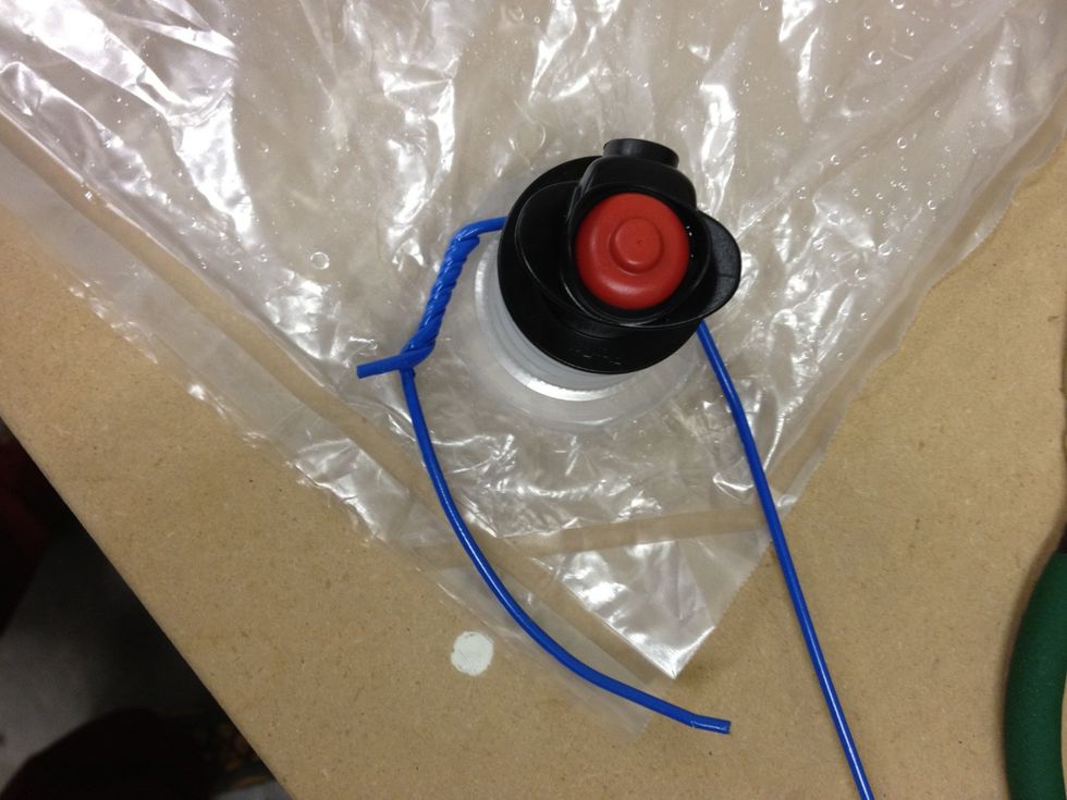 Bend and wrap the hooked end around the valve and fitting and start getting the two pieces close to each other.