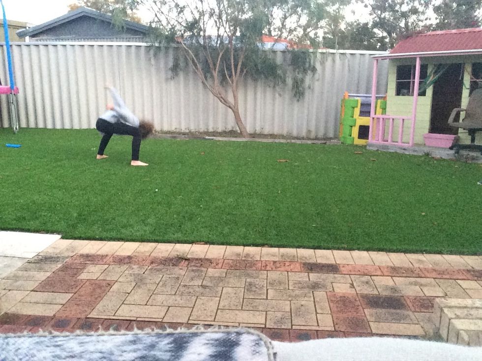 Bend down quite far to get you legs going all the way over without you hands reaching out to the ground.