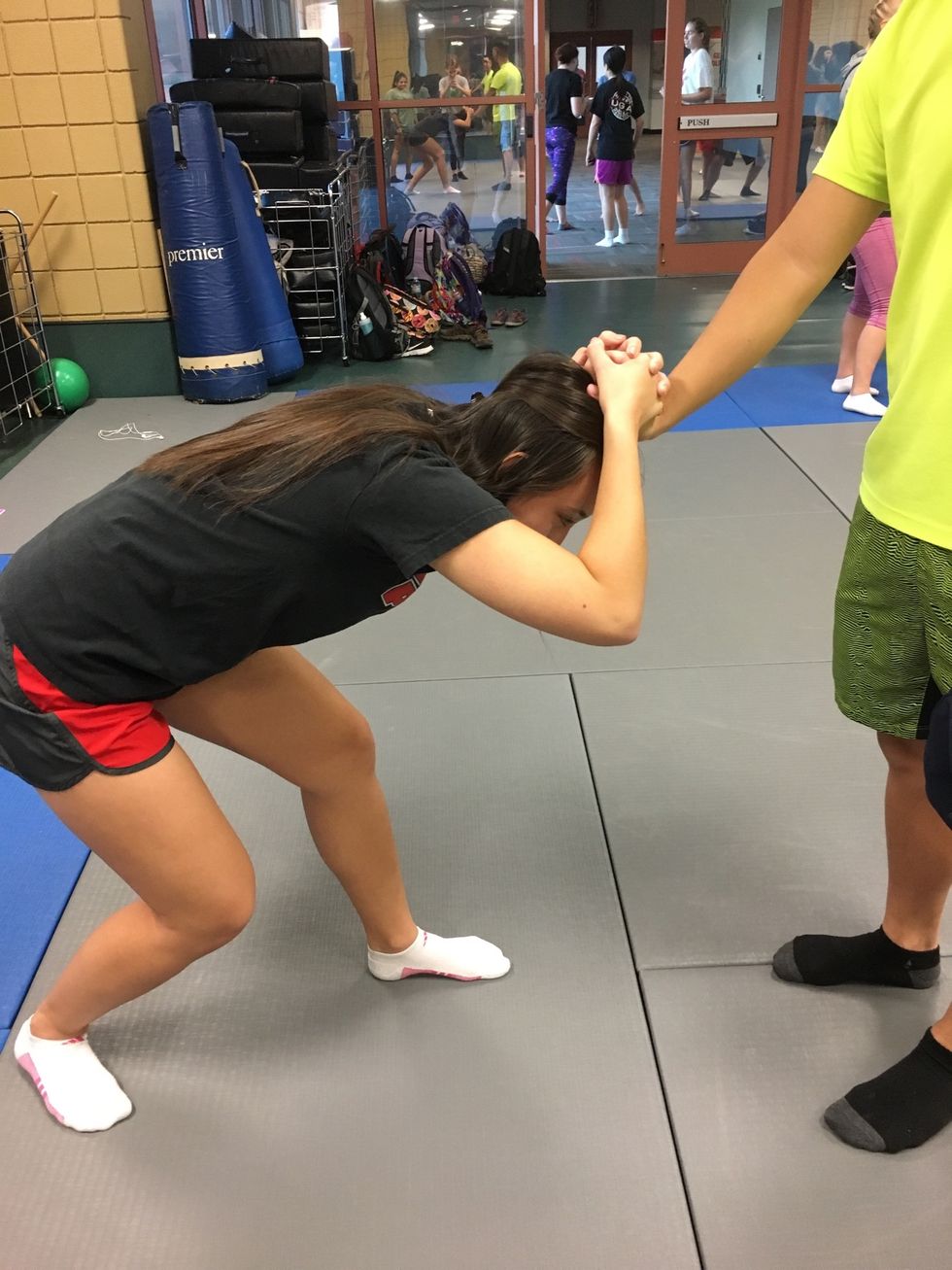 Bend down to put strain on the attackers wrist