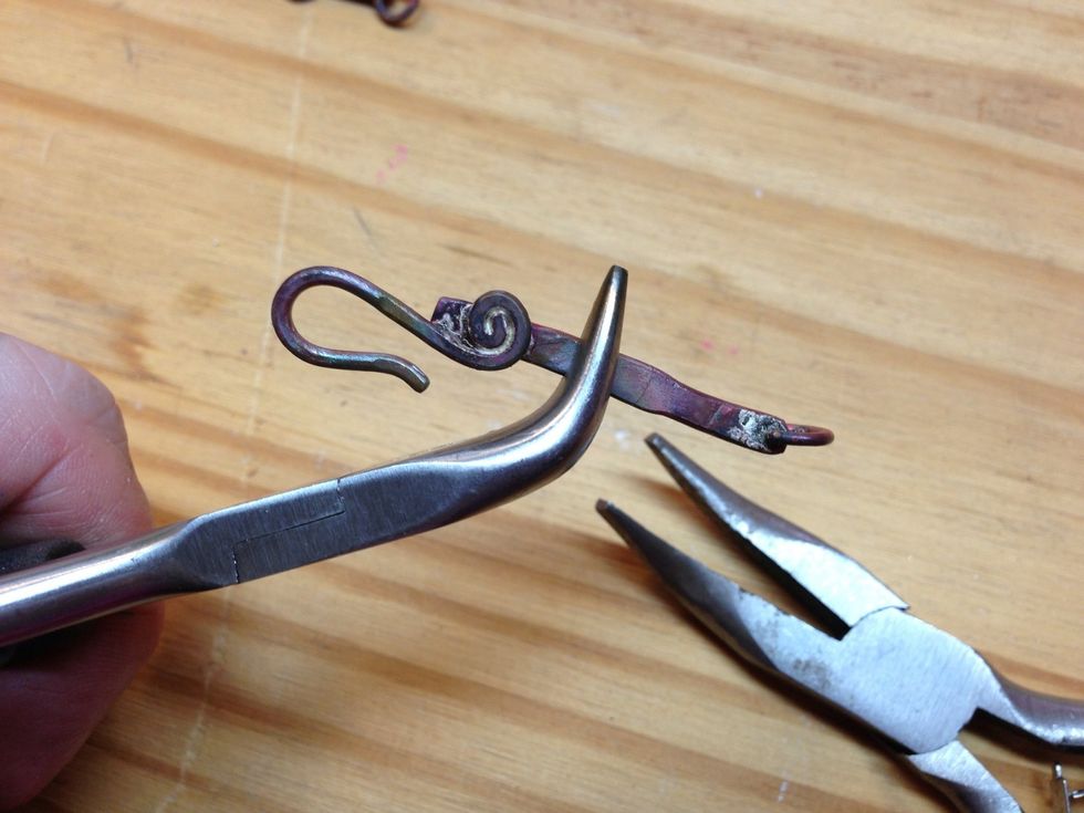 Bend it back into place. Annealed metal is soft and easy to bend. Then curve this piece like the others.