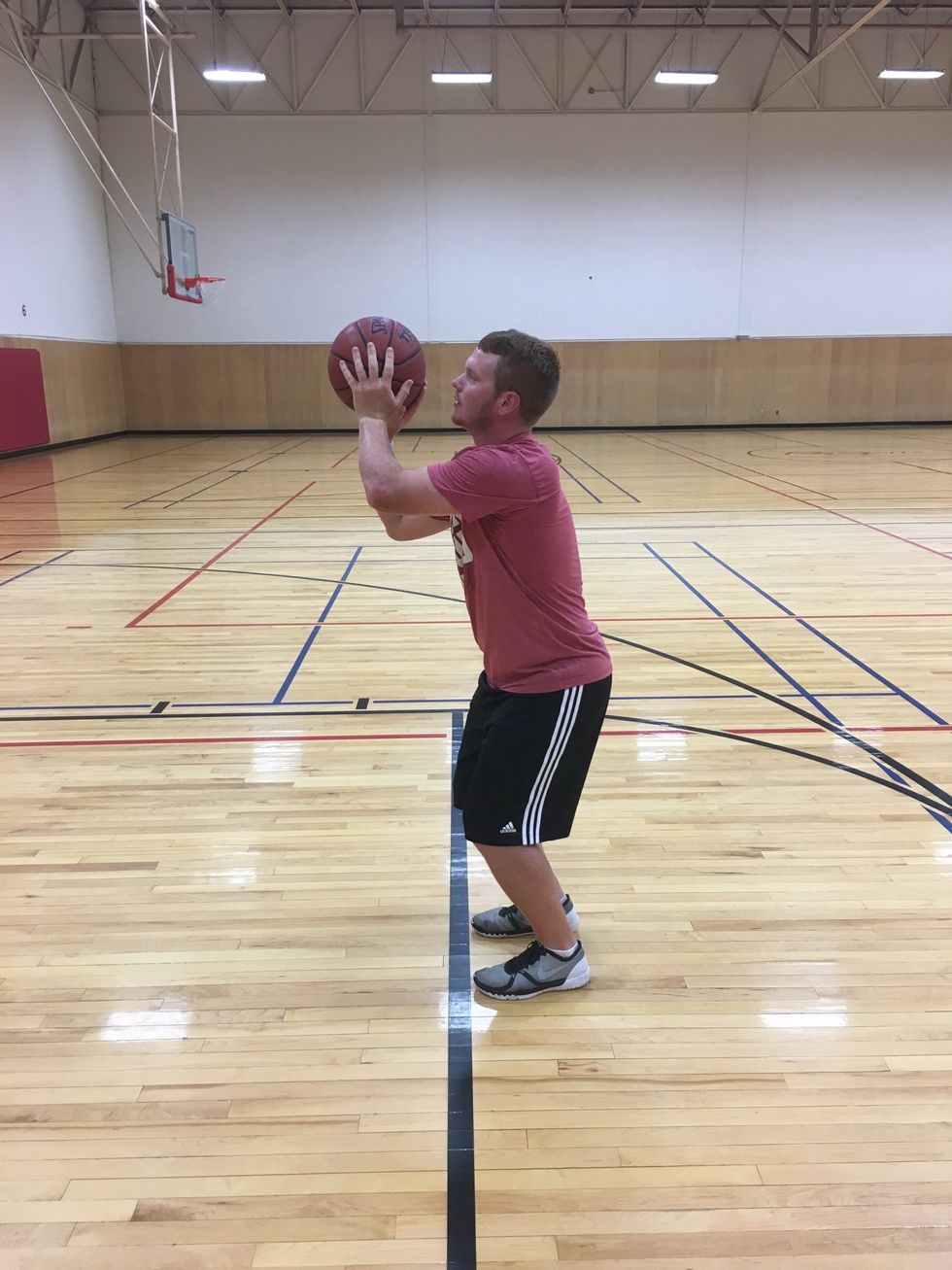 Bend knees. Bring ball up to head. Shooting arm at 90 degree angle. Non shooting hand supports ball.
