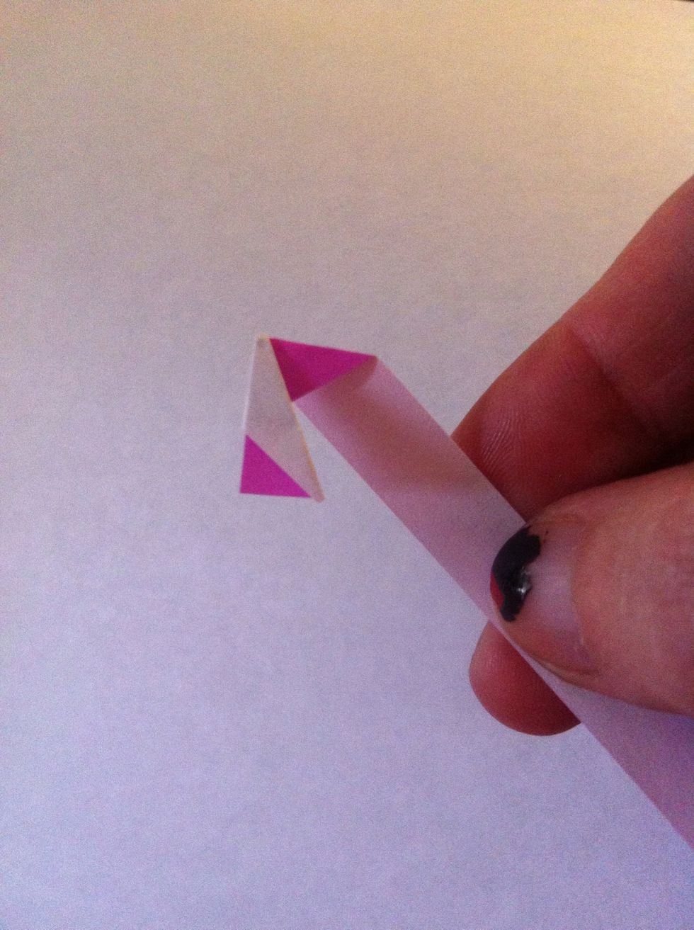Bend the strip back now. You'll be folding the tip of that white triangle back with it. I should say now that there really isn't an exact science to this; just fold back & turn, fold back & turn.