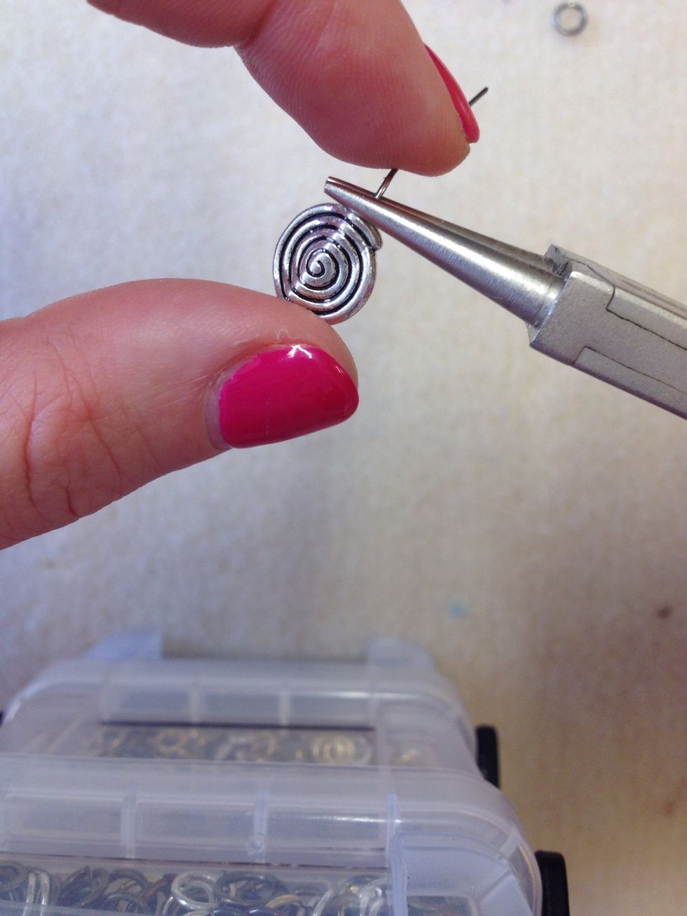 Bend the wire away from you and down the back of the pliers