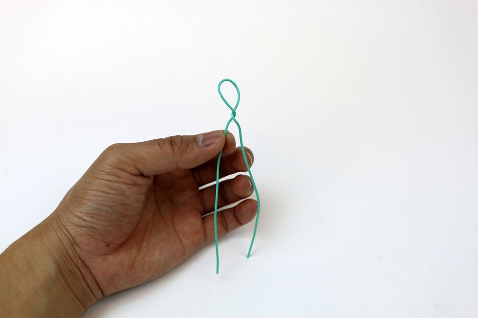 Bend the wire in half and twist to form a loop.