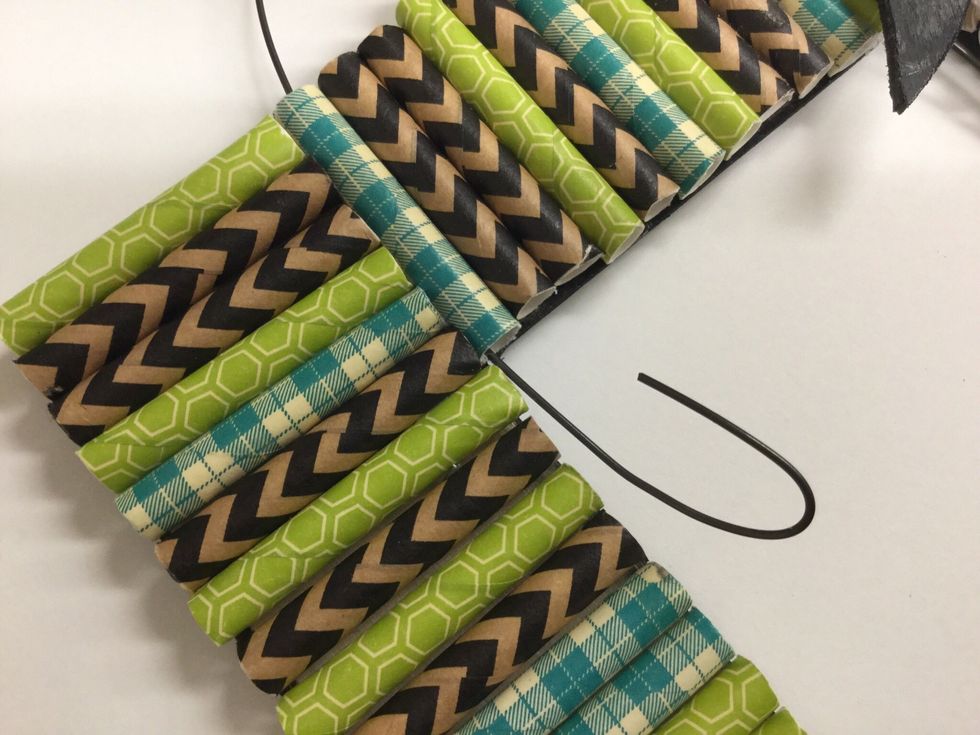 Bend the wire into a U shape. Insert each end of the wire through a straw as shown. Make a loop on each end of the wire.
