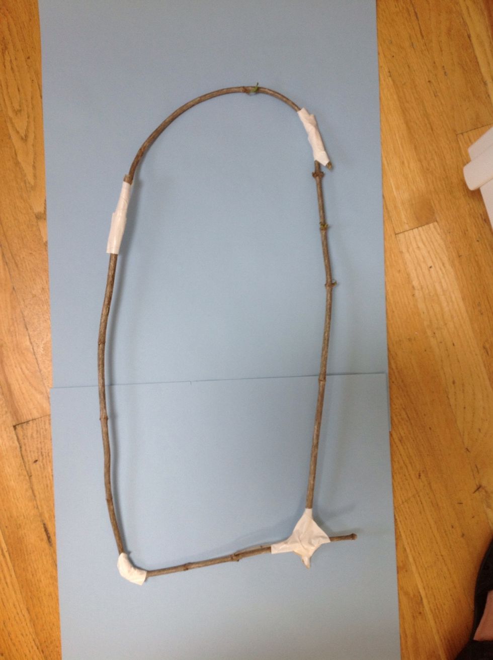 Bend your branch or branches slowly and gently into a rounded  or irregular shape.  Connect the ends with masking tape or duct tape. You can overlap the ends about two inches.