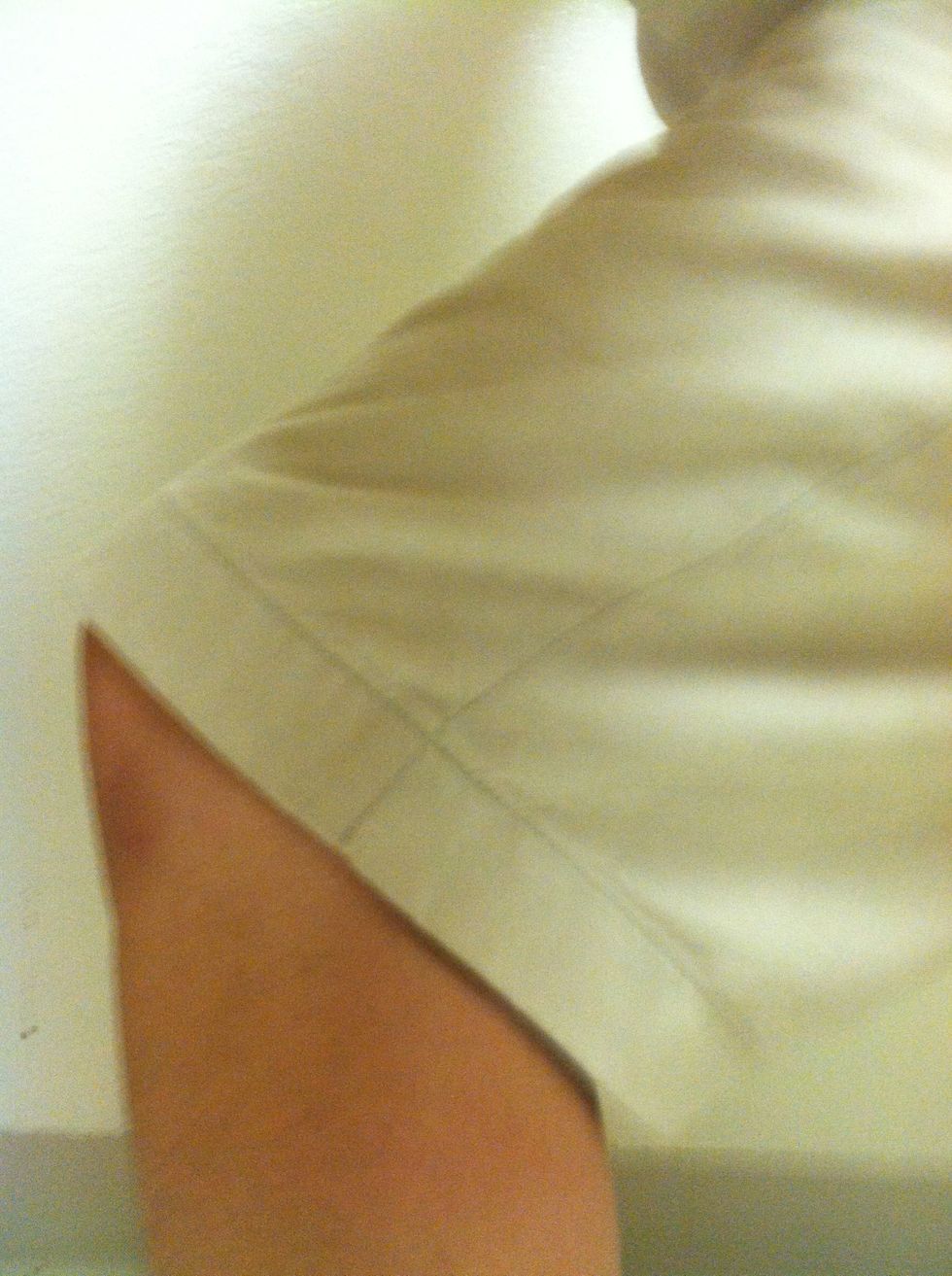 Bend your knees to lower your butt over the horizontal surface of the chair.