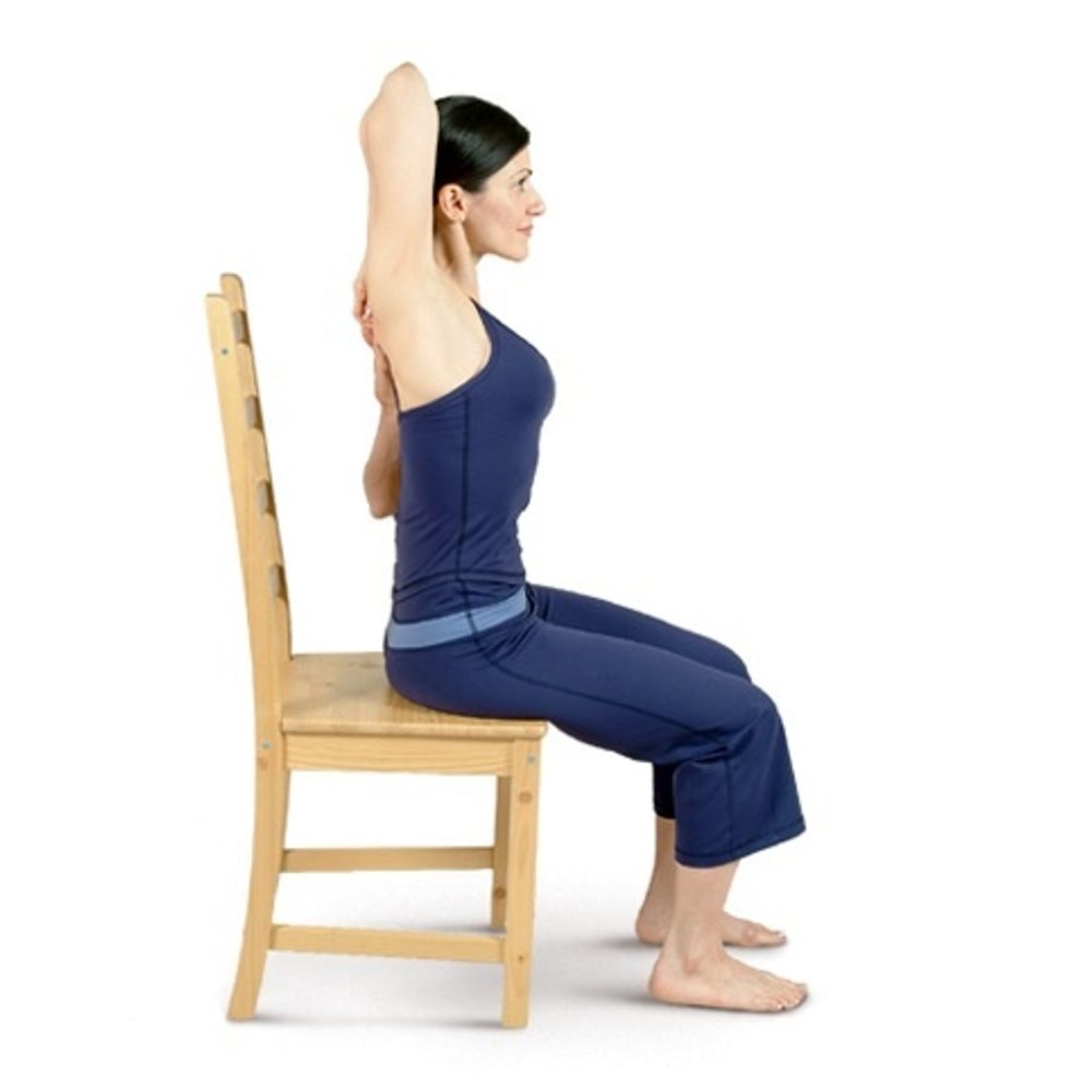 Bend your left elbow & bring your left forearm behind your back, resting the back of your hand in the middle of your back, near your shoulder blades....