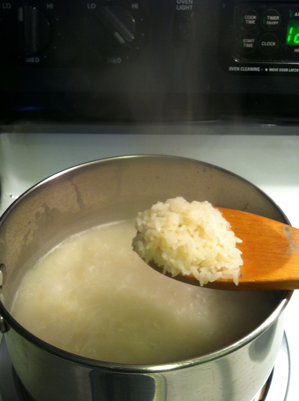 Between a two minutes and a minute left of boiling your water should have a milky (egg nogg-ish) color And rice color changes from the brownish to the same color a the water
