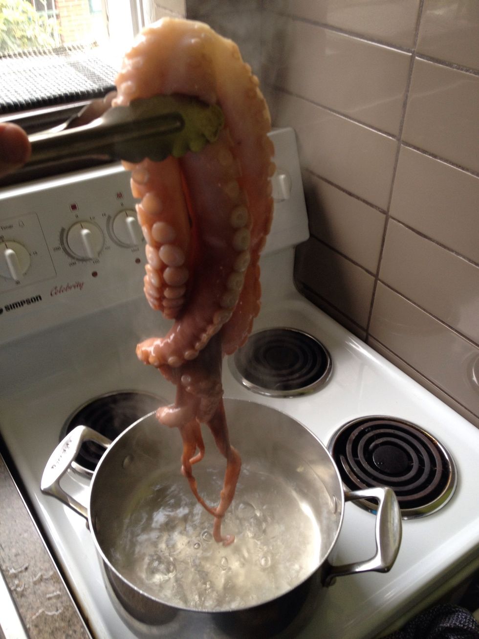 Blanch the octopus 4 times. Place in the water for 15 seconds, lift out. Bring back to boil and repeat