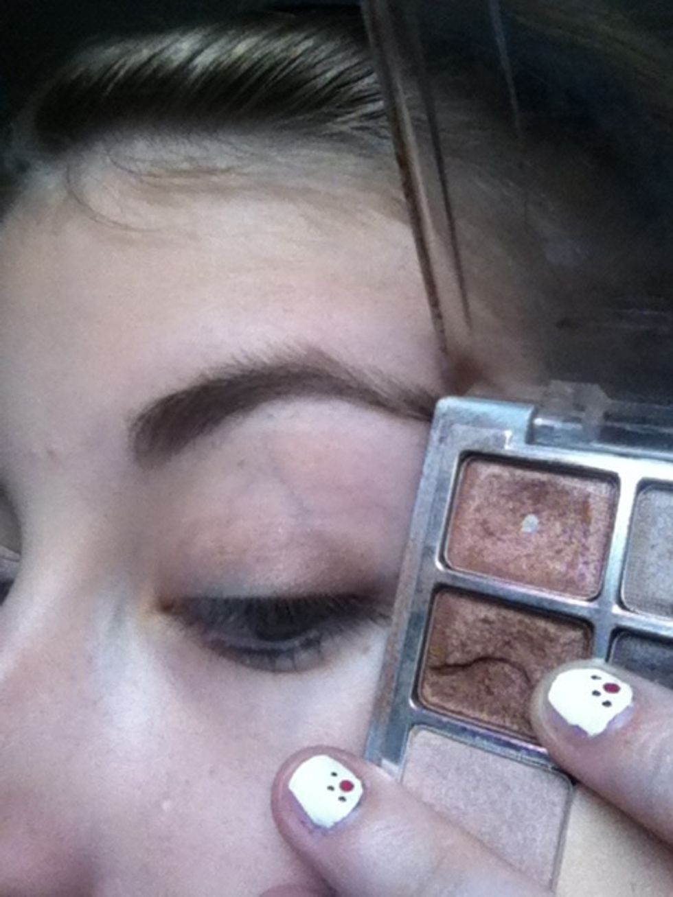Blend dark bronze onto the outer corner of the eyelid.