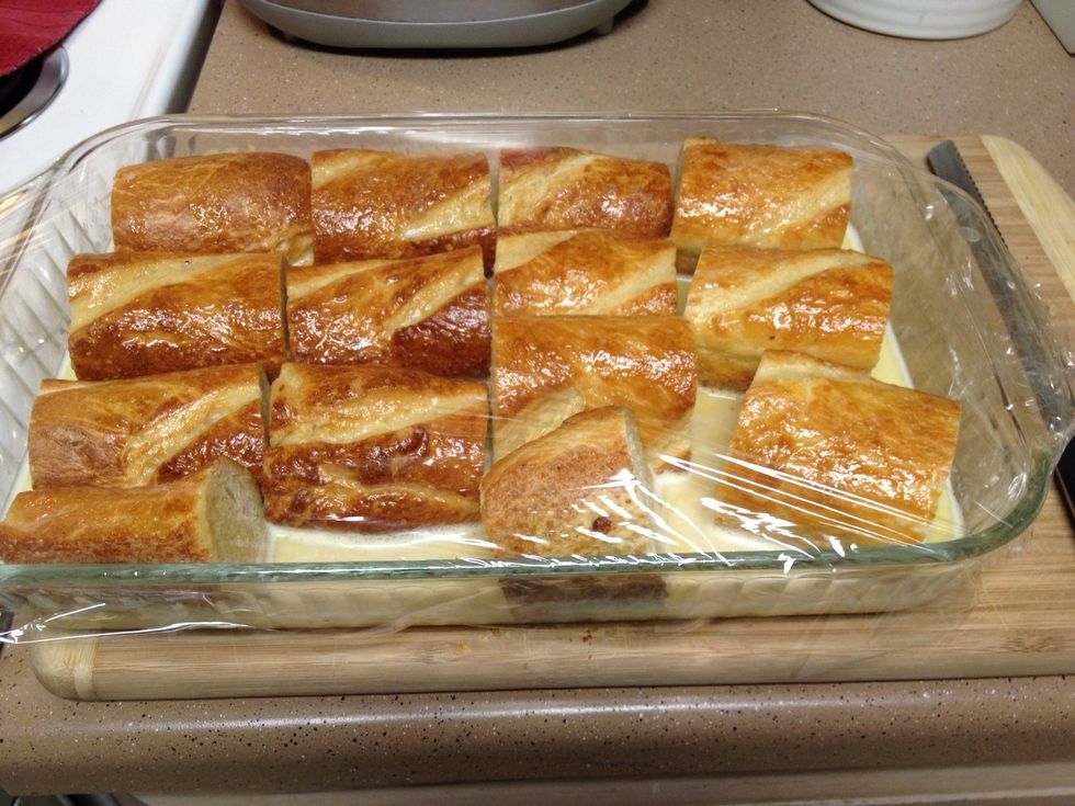Blend eggs, milk and vanilla & pour into a 9x16 glass pan. Cut the Baguettes into 4" lengths and lay into the egg mix sideways, cover with plastic wrap and fridge overnight.