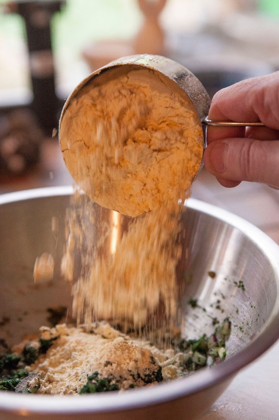 Blend in the besan (garbanzo flour).You can add up to 1/4 cup of water to make a smooth mixture. If it's too  soft you can always add more besan. Add in salt to taste.