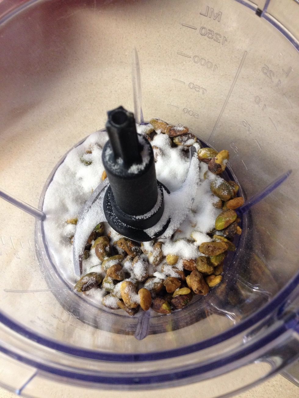 Blend one cup of pistachios with a quarter cup of sugar until finely ground