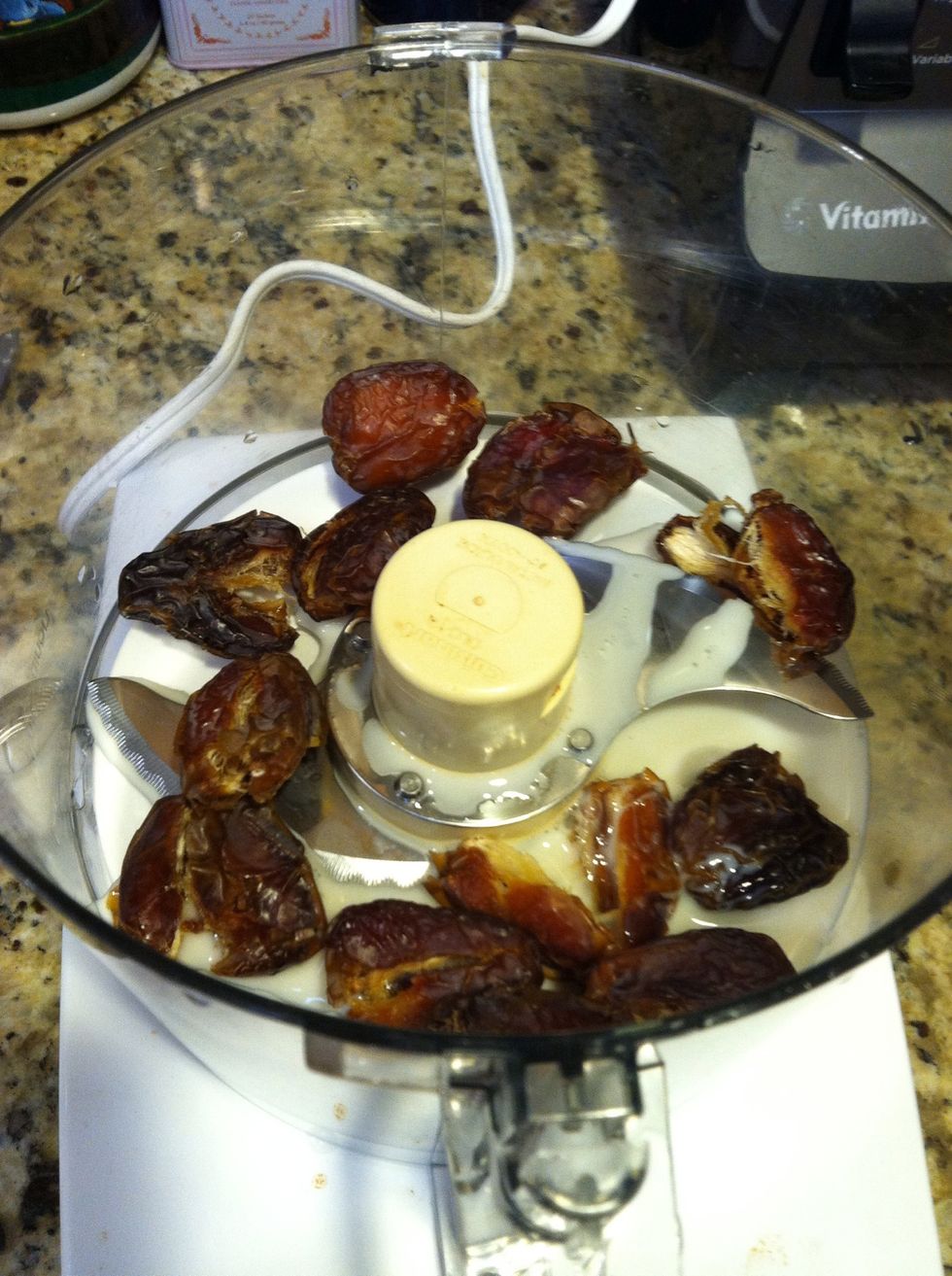 Blend pitted dates and almond milk in a food processor until roughly chopped.