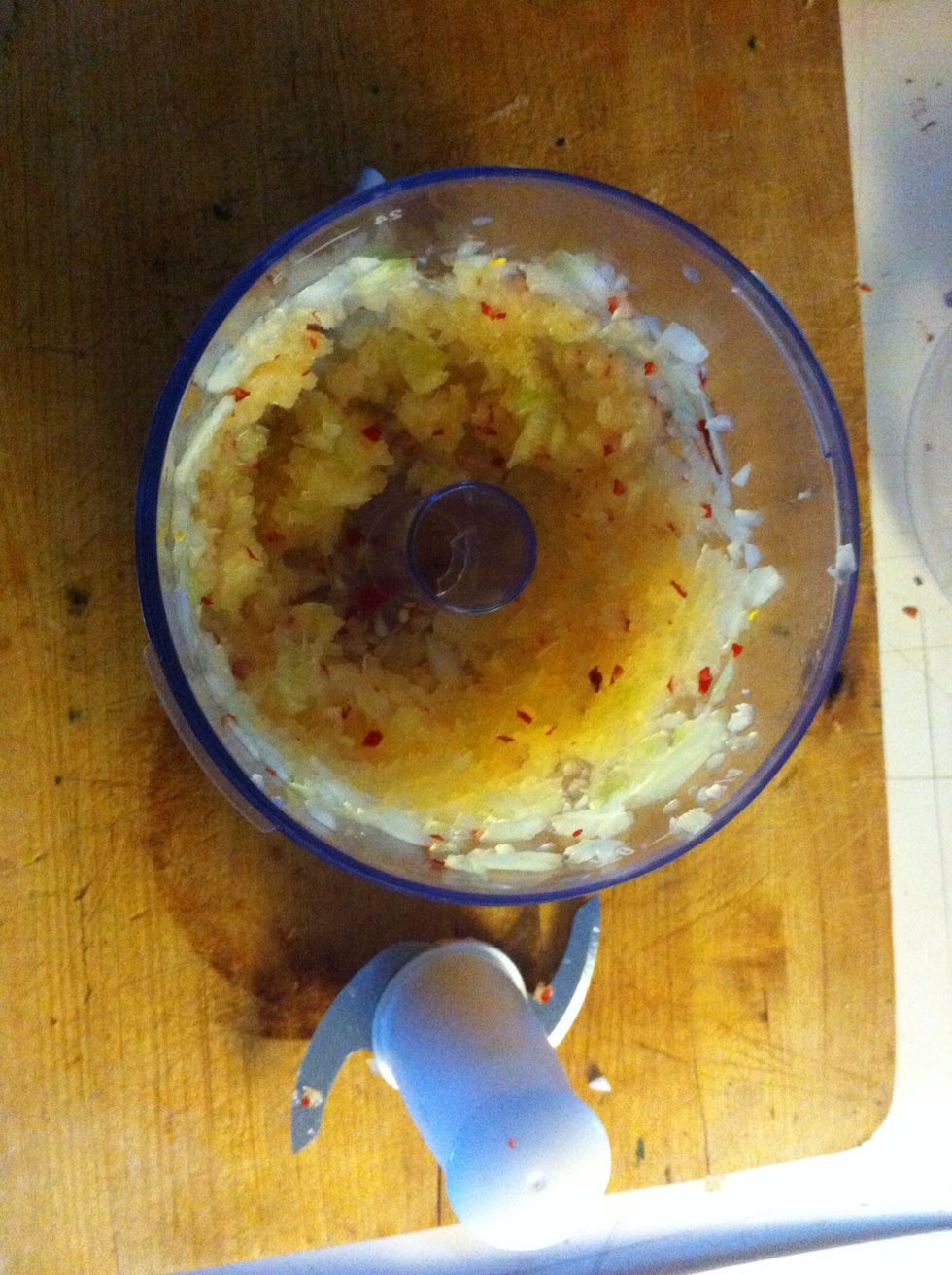 Blend the onion and three dried chilies (seeds removed) in a food processor until well blended, as paste as paste can be. Like, pasty.