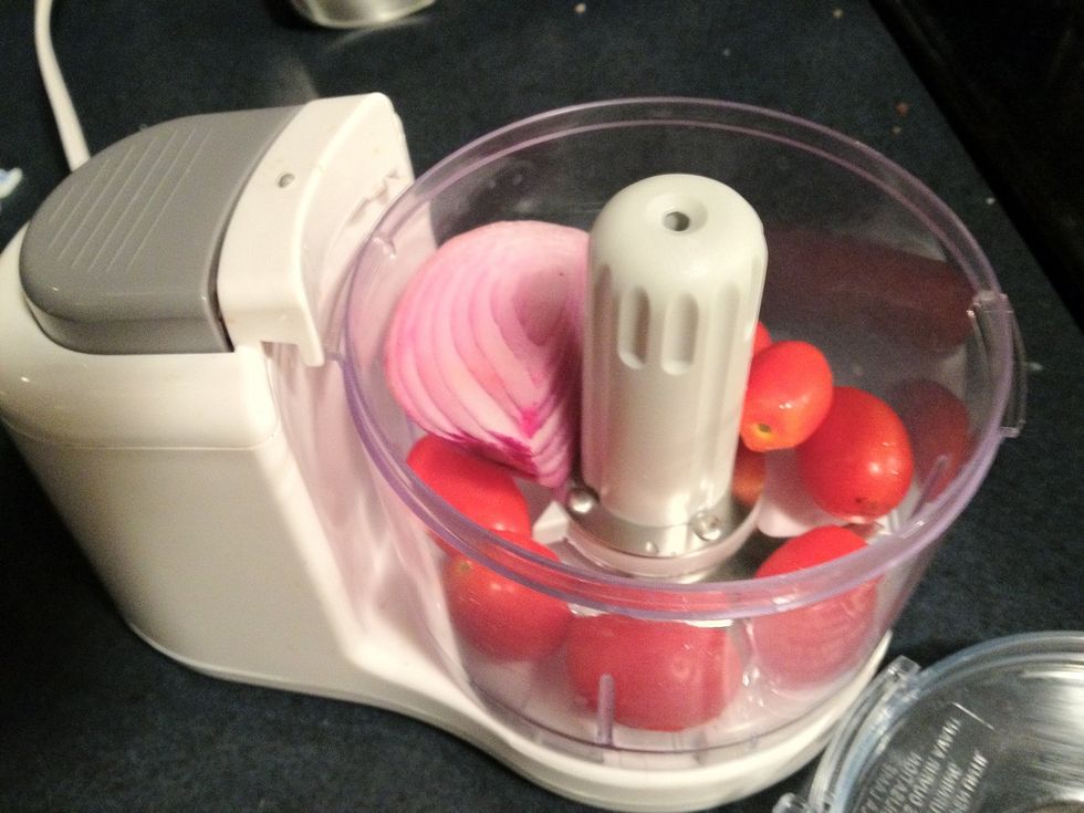 Blend the onion & tomatoes in a food processor. You can chop them if you prefer but this takes 10 sec. Cherry or grape tomatoes work well since they don't leave a lot of juice or water down the guac