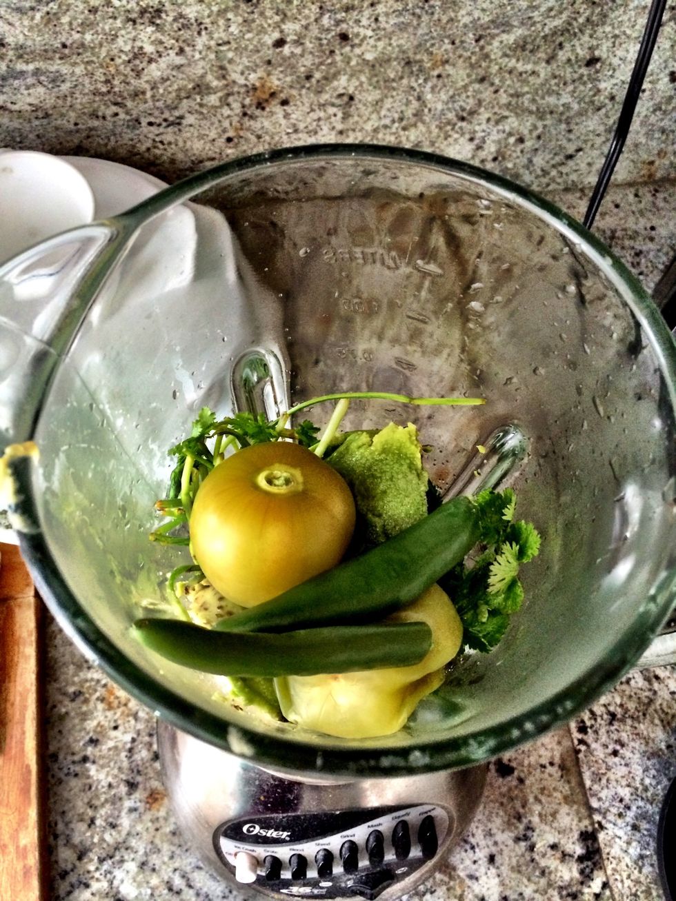 Blend together boiled tomatillos, green chilies, avocado, cilantro, salt to taste, and water as needed (based on whether you like it thick or thin).