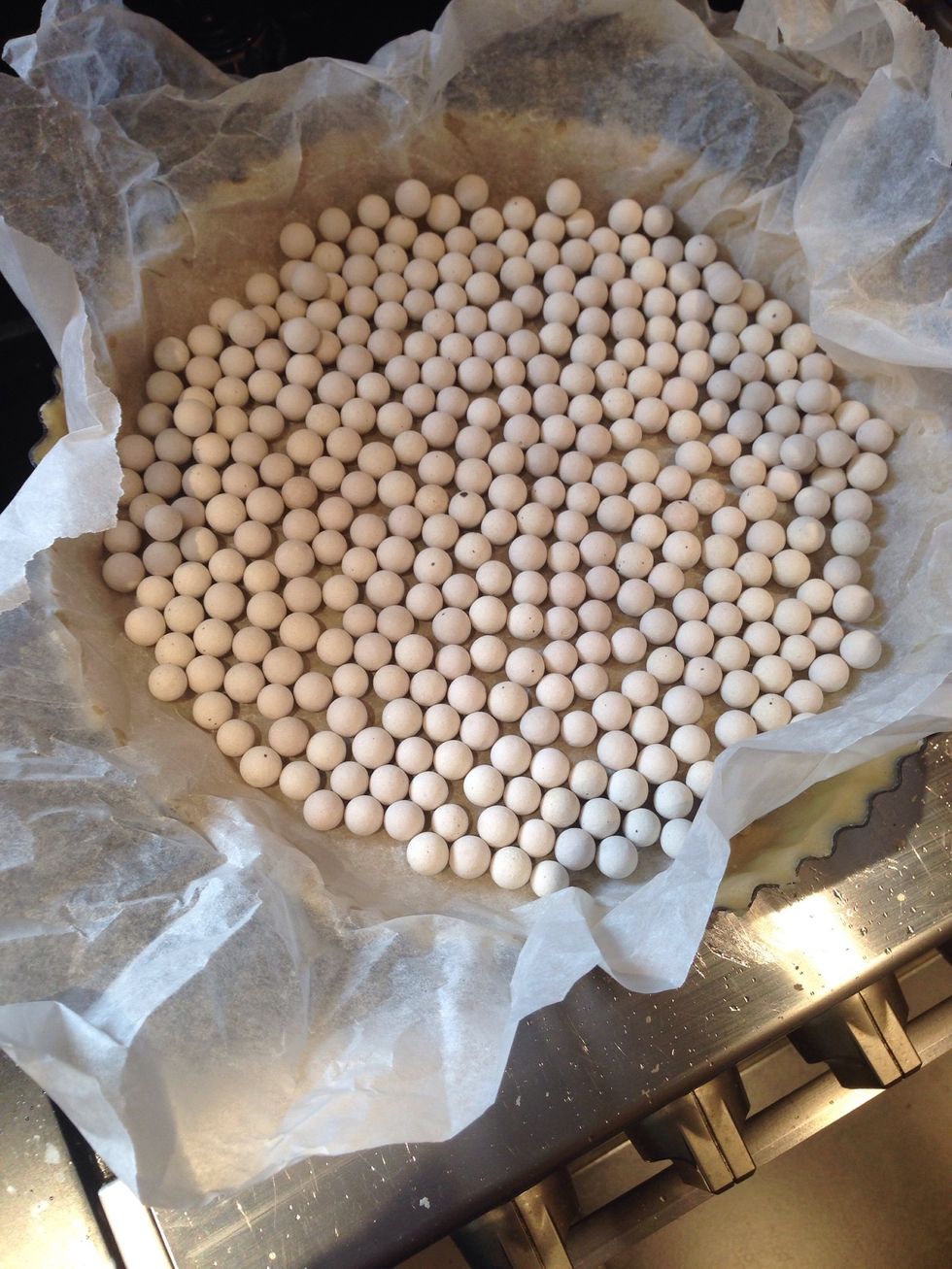 Blind bake the pastry for 15 minutes at 180\u00b0C. This means cover the pastry with grease proof paper and tip in baking beads (or uncooked rice).