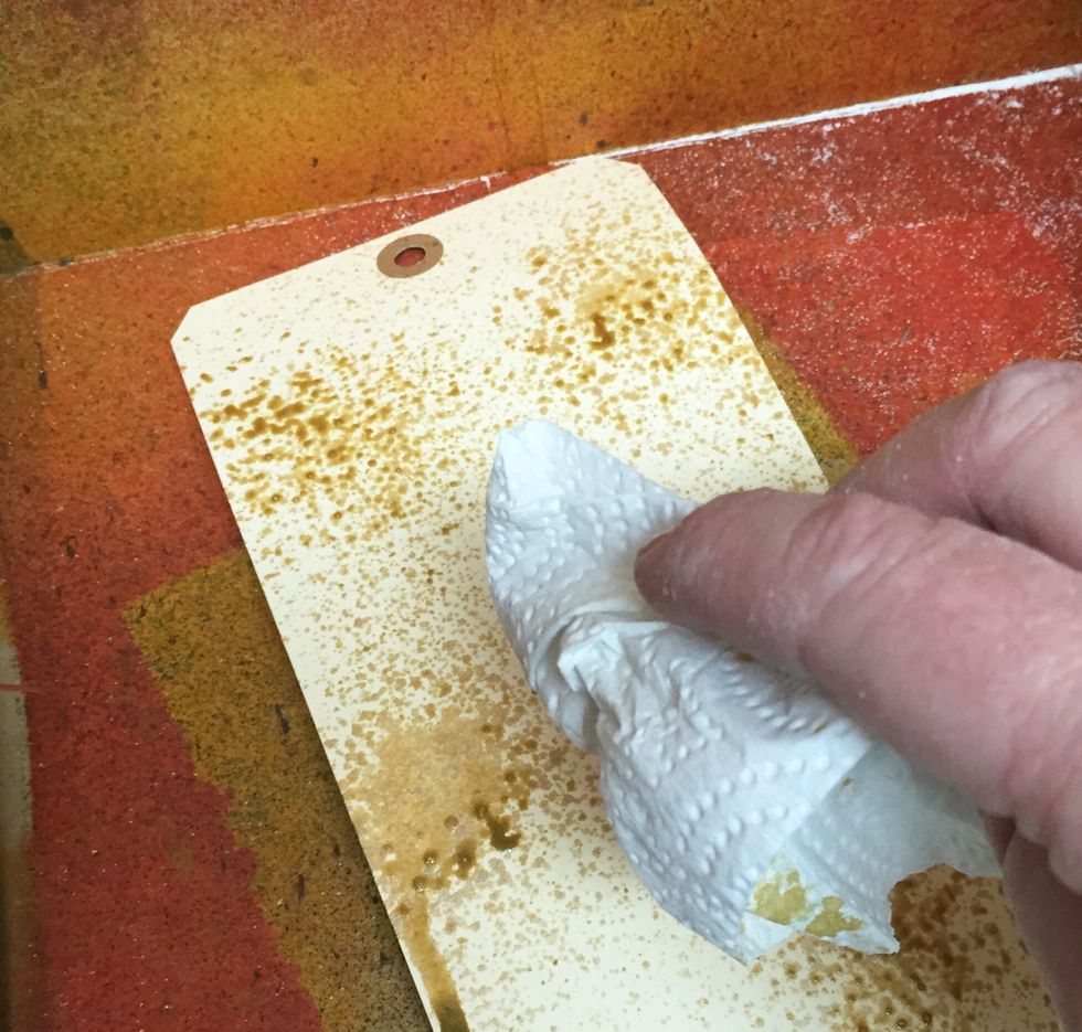 blot with paper towels to remove and spread excess ink