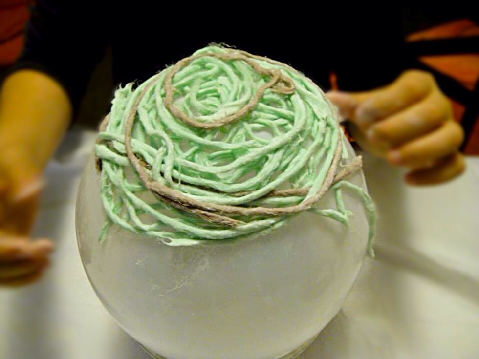 Blow balloons to preferable size and place them in the bowl for stability. Let your kids make a design on top of the balloon with glue covered yarn.