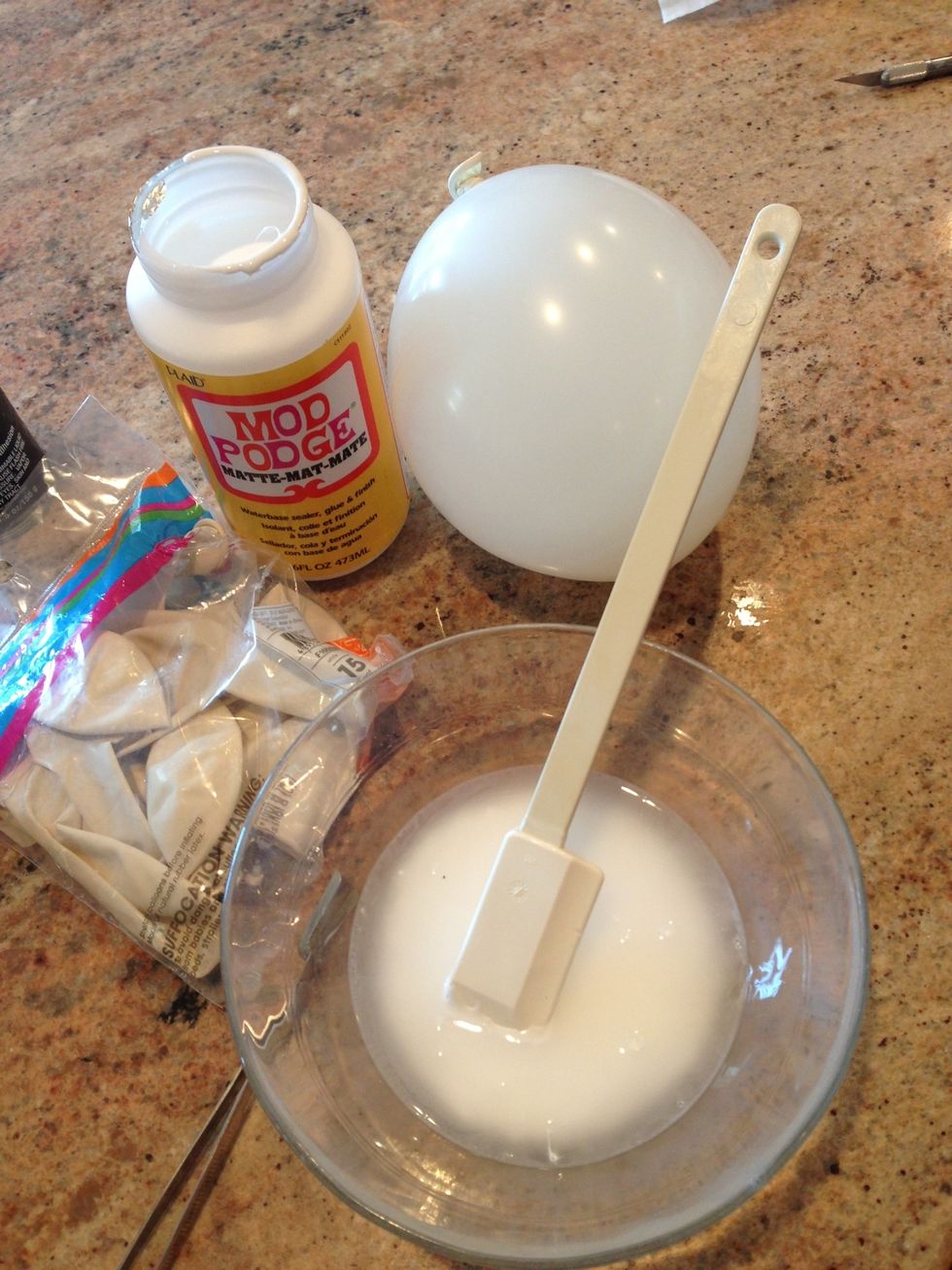 Blow up balloon and tie. Thin Mod Podge with water