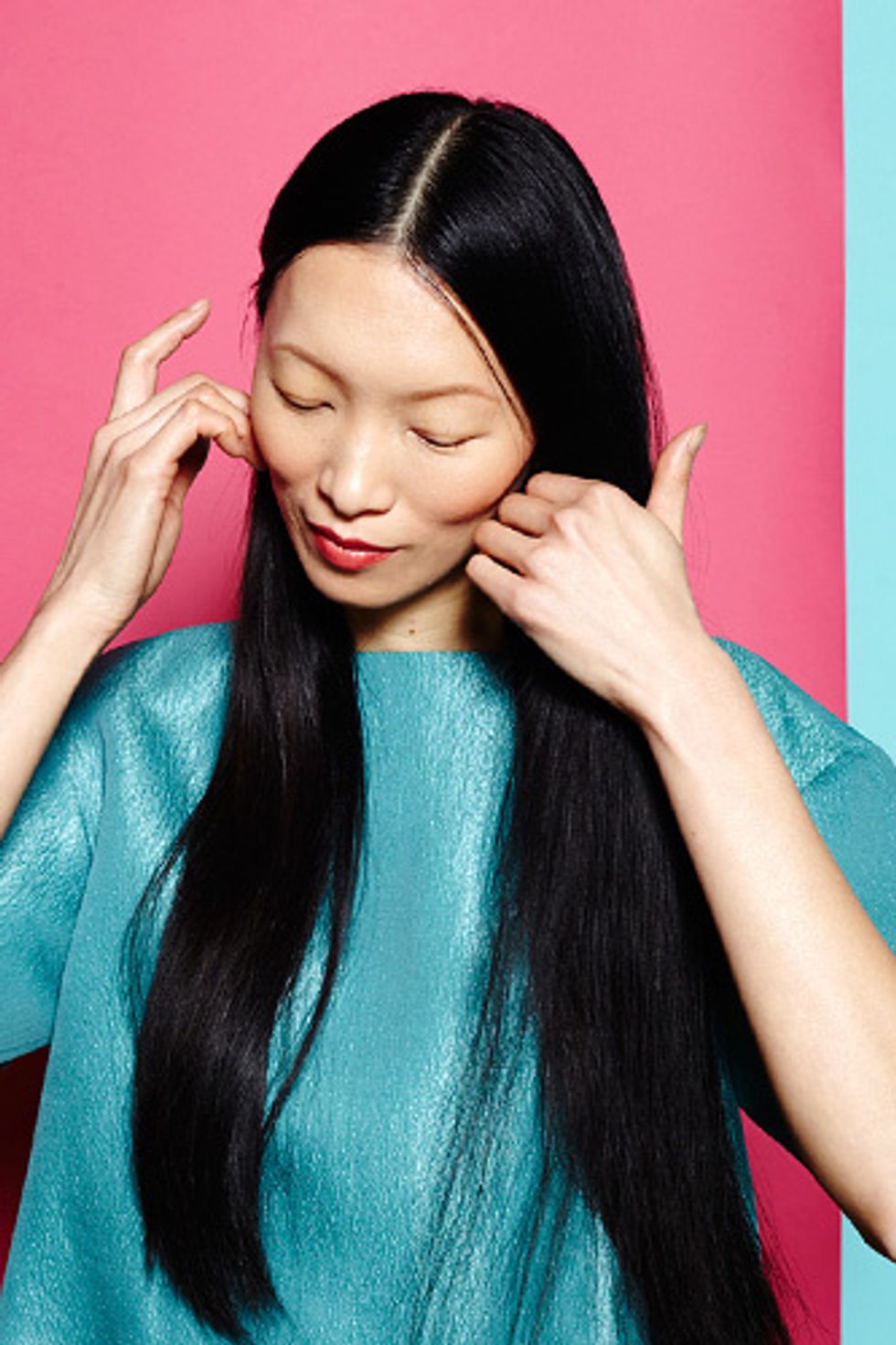 Blowdry your hair roughly, working in a prep product to give it some extra hold, such as Aveda's Pure Abundance Style Prep. Then, divide your hair into two even sections.