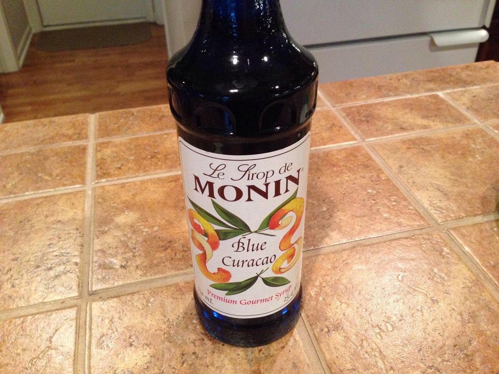 Blue Cura\u00e7ao syrup can be found in liquor stores but has alcohol in it. I had to buy online for the non-alcoholic version.