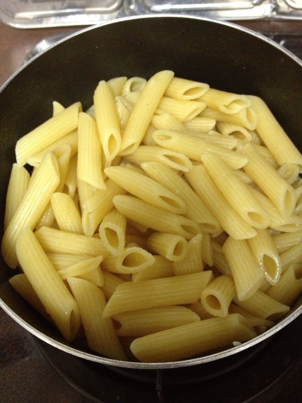 Boil 5 liter of water in pot. Add 2 teaspoon of salt into in pot. Add penne pasta in to pot. Cook for about 14 minutes. Constantly stir the pasta so that it doesn't stick to each other.