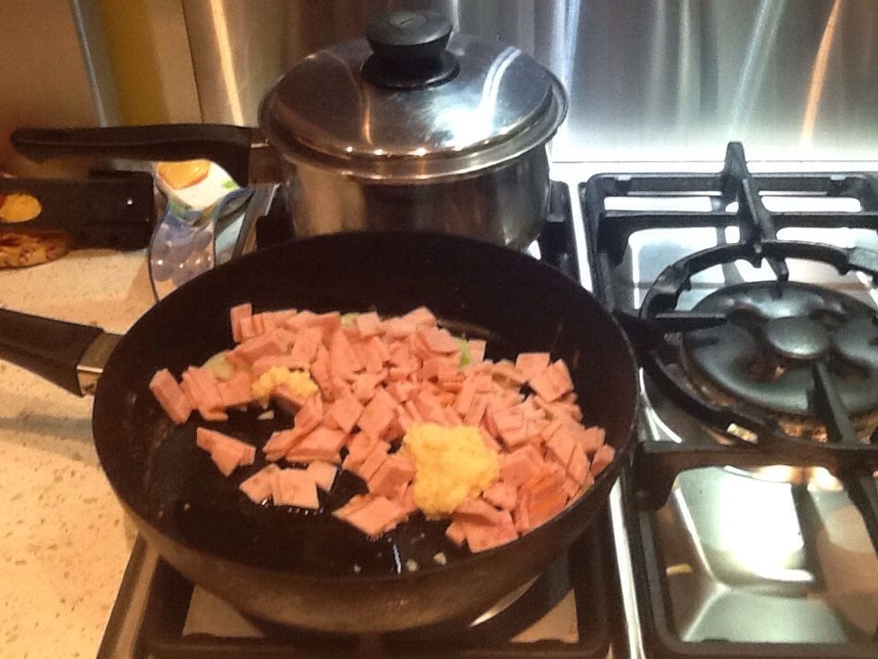Boil a pot for the pasta. Mean while, in a medium pan, melt butter. Add onion, bacon and garlic. Saut\u00e9 for 5 minutes.