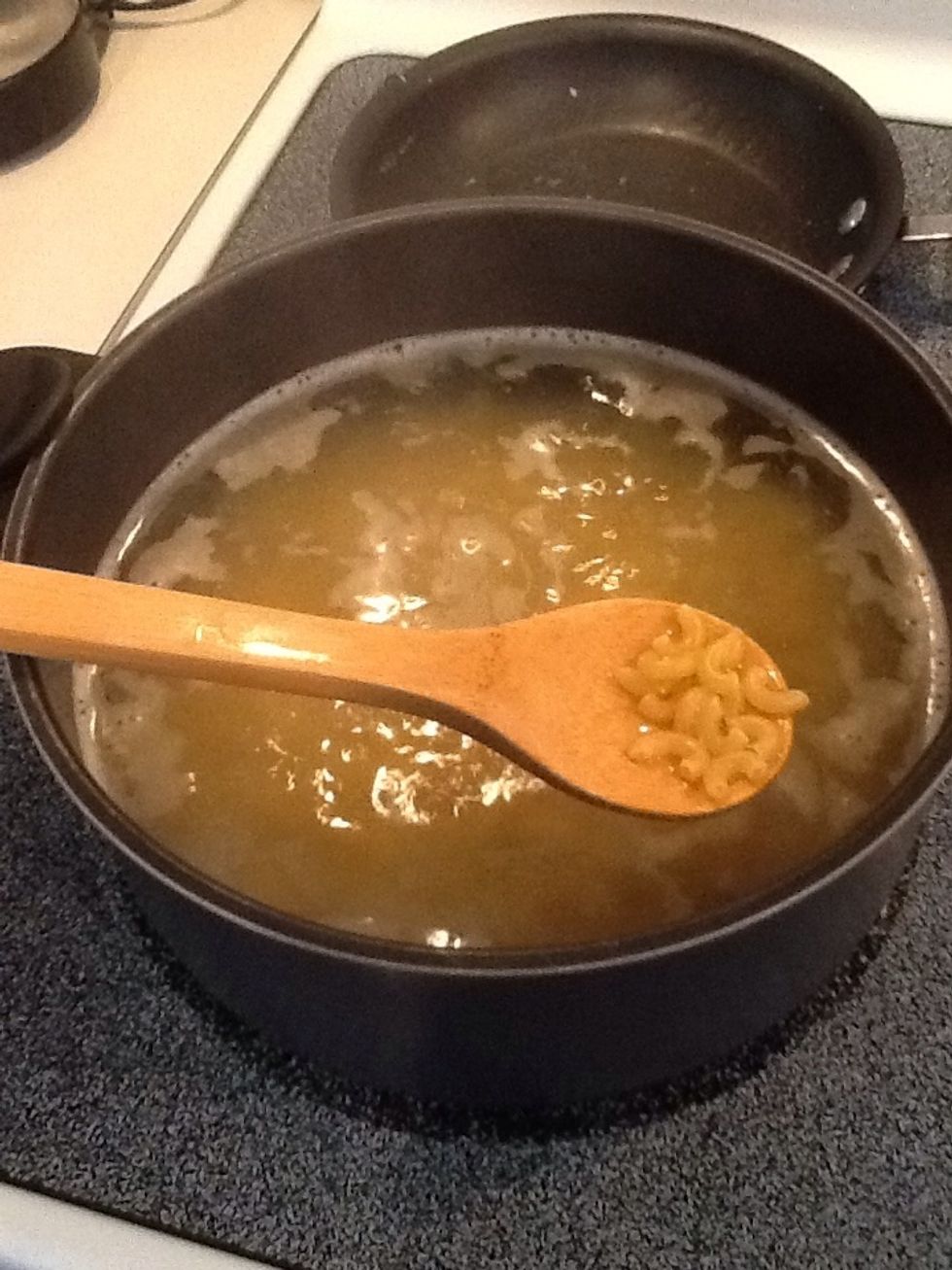 Boil a pot of water. Add the box of uncooked macaroni and boil 8-10 minutes.