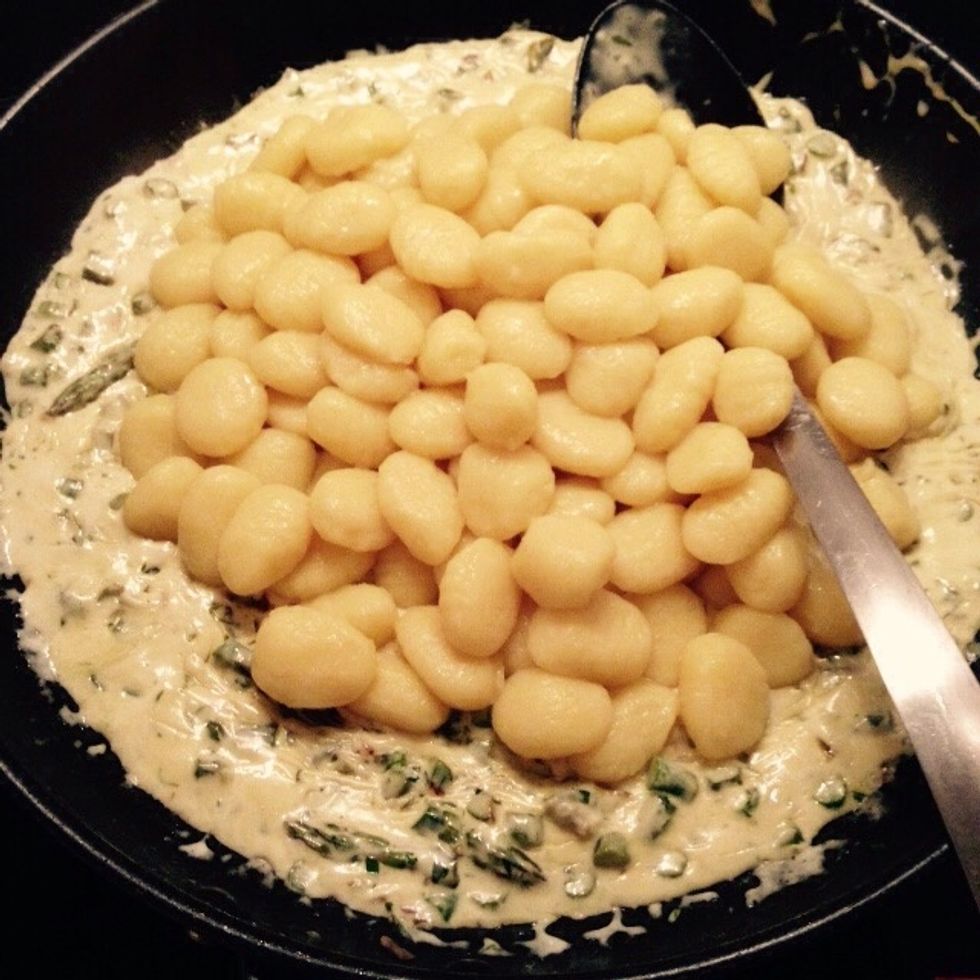 Boil and drain the gnocchi, then toss them in the pan